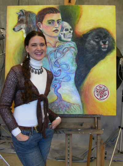 Kristin Schauk, shown here with self-portrait, says she cannot  imagine being an educator without being an artist, and vice versa. Photo courtesy: Clatsop Community College